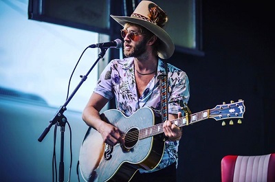 Paul performing solo on a program. Know about his career, profession and more